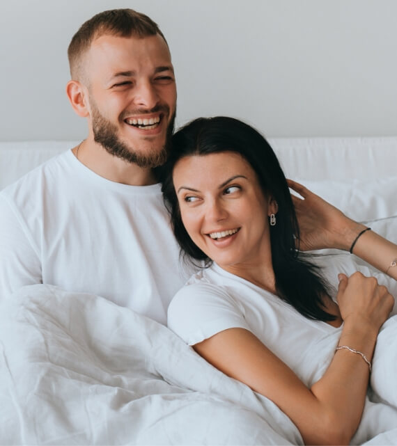laughing-young-couple-awakening-at-new-apartment-h-2023-11-27-04-57-55-utc (1)